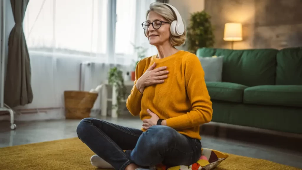 Meditação com fones ouvindo playlist devocional em 2025.